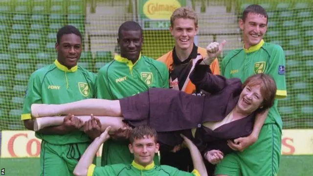 Delia Smith is held aloft by Norwich players