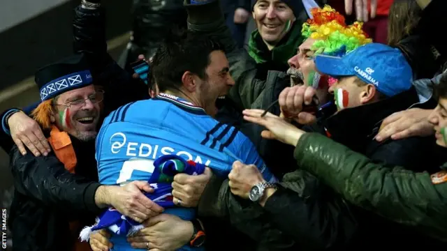 Italy's scrum half Edoardo Gori celebrates with fans