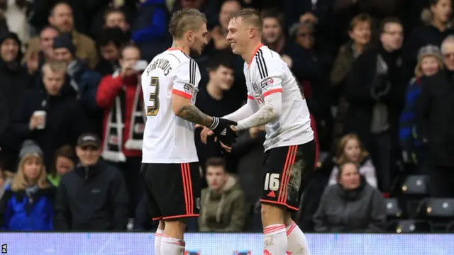 Cauley Woodrow is congratulated by team mate Kostas Stafylidis