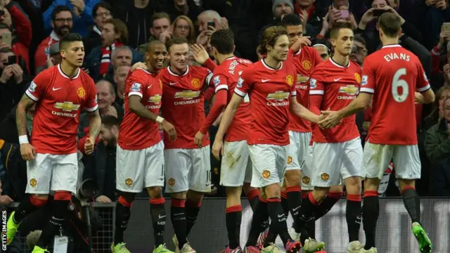 Manchester United players celebrate Wayne Rooney's second goal