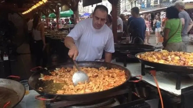 A man cooks Paella