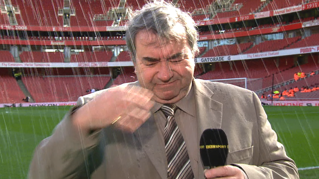 Jonathan Pearce gets soaked by a sprinkler