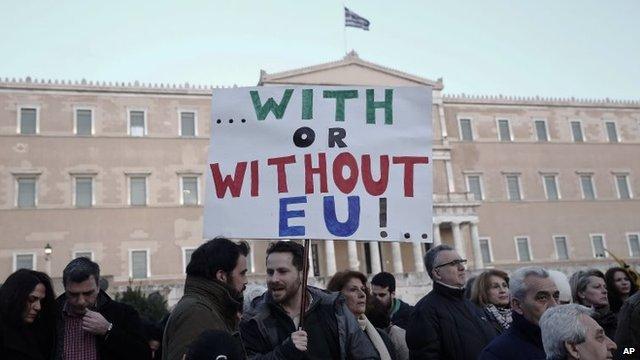 A pro-government protester holds a placard in front of Greece's parliament on 15 February