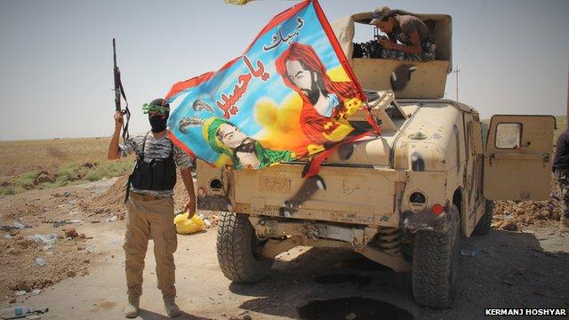 Fighters from the Iranian Khorasani brigade in a town east of Tirkit