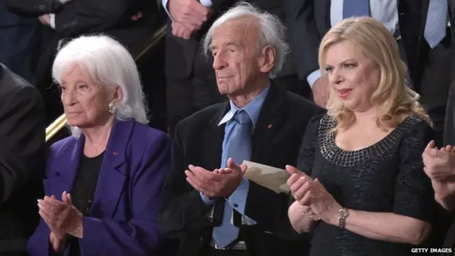 Elie Wiesel(C), his wife, Marion Erster Rose and Sara Netanyahu (R) applaud as Israel"s Prime Minister Benjamin Netanyahu arrives to address to Congress on March 3, 2015