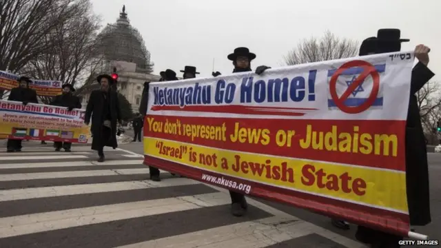 Anti-Zionist ultra-orthodox Jews of the Naturei Kartra movement march across a street during a protest outside the Capitol Hill where Israeli Prime Minister Benjamin Netanyahu addressed a joint session of Congress in Washington, DC, 3 March 2015