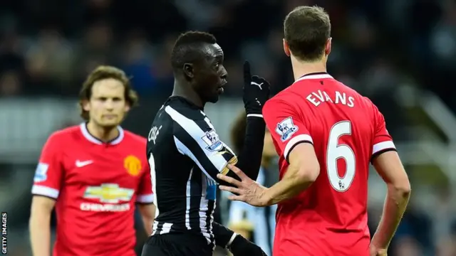 Papiss Cisse remonstrates with Jonny Evans