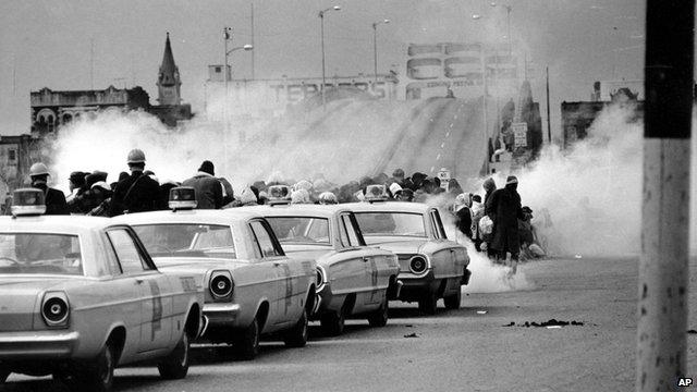 Tear gas fumes fill the air as state troopers break up a demonstration march in Selma, Alabama on 7 March 1965