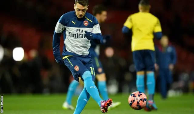 Mesut Oezil warms up