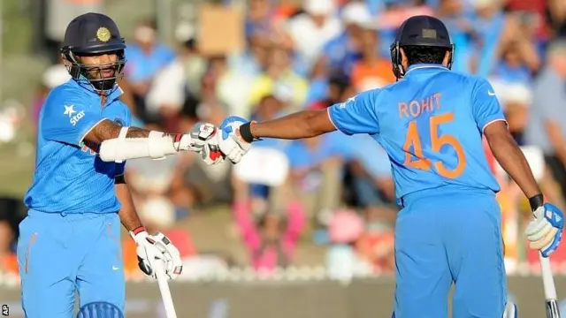 India batsman Shikhar Dhawan, left, celebrates with Rohit Sharma