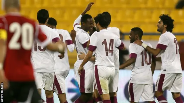 Qatar's national football team celebrate a goal