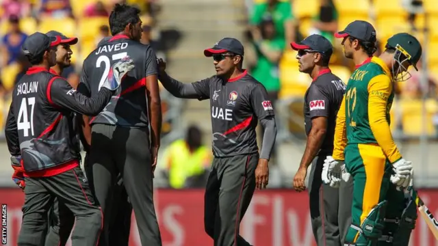 The UAE celebrate Quinton de Kock's wicket