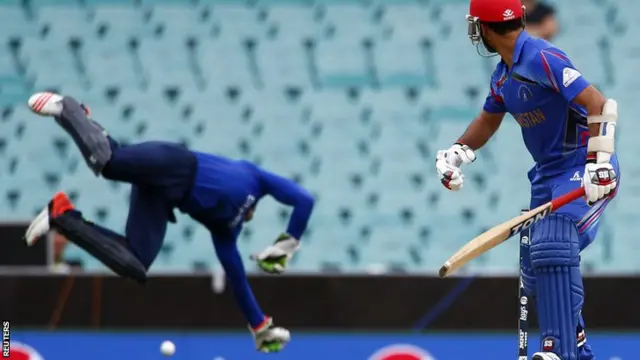 Nawroz Mangal sees the ball defy Jos Buttler