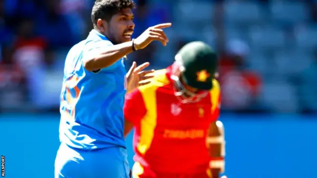 Umesh Yadav celebrates taking the wicket of Hamilton Masakadza