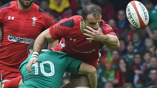 Johnny Sexton tackles Jamie Roberts