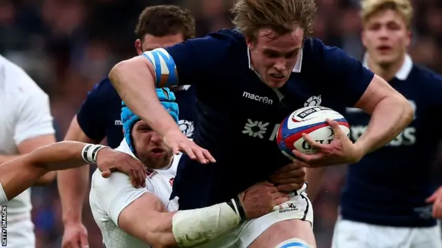 Jonny Gray is tackled by James Haskell