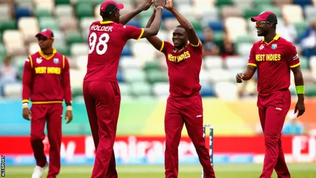 Jerome Taylor, centre, is congratulated by Jason Holder