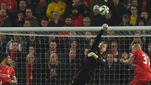 Liverpool keeper Simon Mignolet punches clear