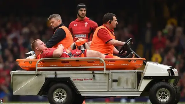 Samson Lee is taken off the field after suffering injury