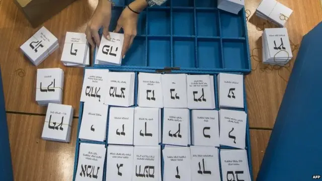 An Israeli election worker arranges ballots at a polling station in Haifa (17 March 2015)