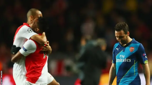 Santi Cazorla (right) walks off dejected