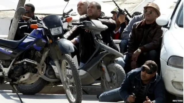 Police officers are seen on the pavement outside parliament in Tunis March 18, 2015