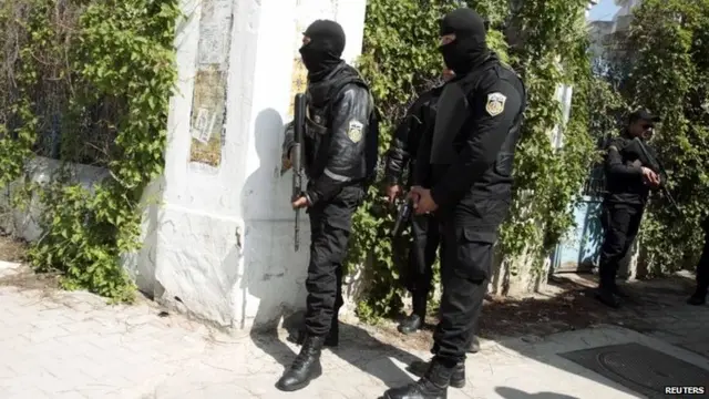 Police officers stand outside parliament in Tunis March 18, 2015.