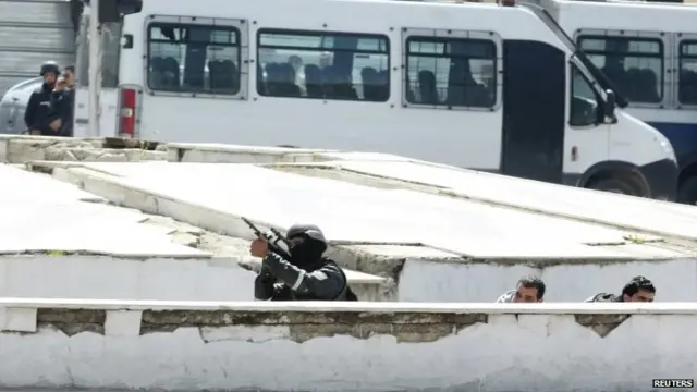 Police officers are seen outside parliament in Tunis March 18, 2015.