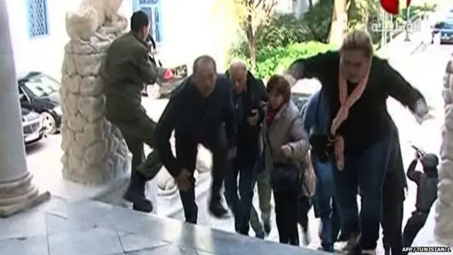 An image grab taken from the state-run Tunisia 1 channel on March 18, 2015 shows people escaping from Tunis" famed Bardo Museum during an attack