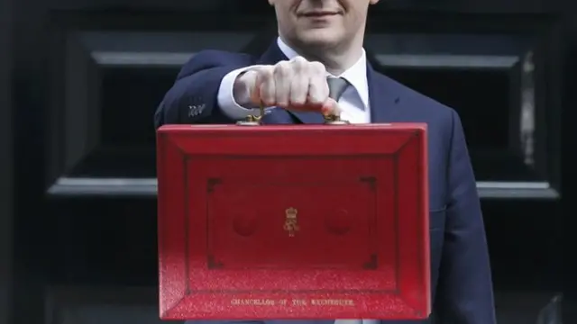 George Osborne holds up Budget case as he stands outside Number 11