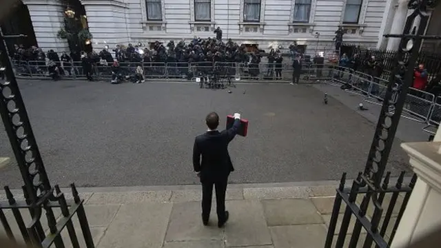 George Osborne raises his Budget box to photographers outside Number 11 Downing Street