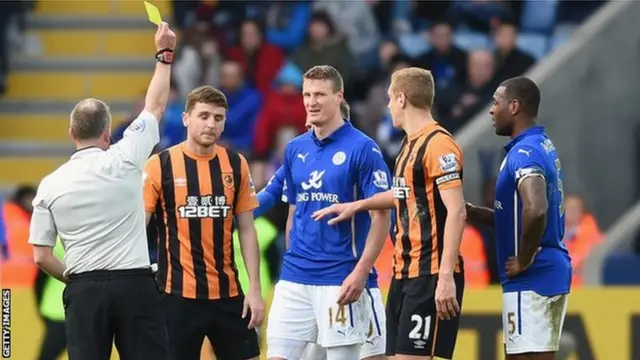 Alex Bruce is shown a yellow card at Leicester