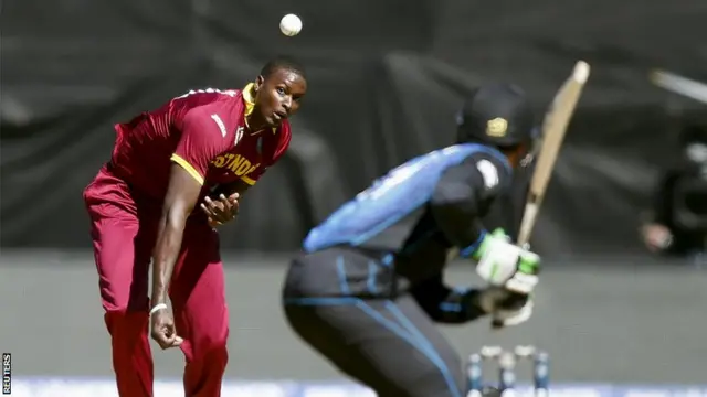 Jason Holder delivers a ball to New Zealand"s Martin Guptil