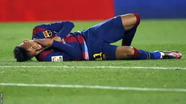 Neymar clutches his neck