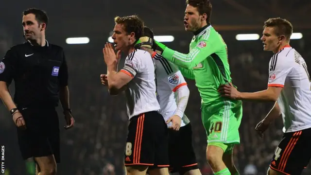 Fulham players protest to the referee against Leeds