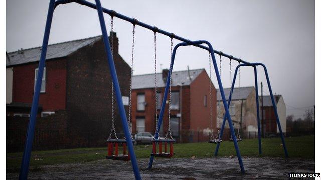 swings by terraced houses