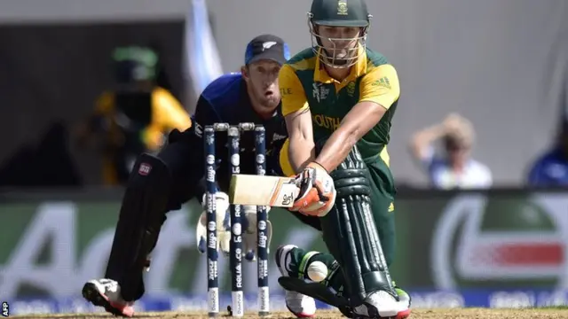 South African batsman Rilee Rossouw (R) plays a shot watched by New Zealand keeper Luke Ronchi during the Cricket World Cup semi-final match between New Zealand and South Africa at Eden Park