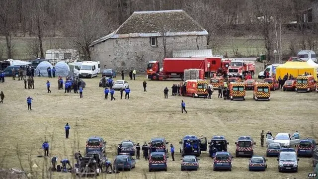 French emergency services workers (back) and members of the French gendarmerie gather in Seyne, south-eastern France, on March 24, 2015, near the site where a Germanwings Airbus A320 crashed in the French Alps.