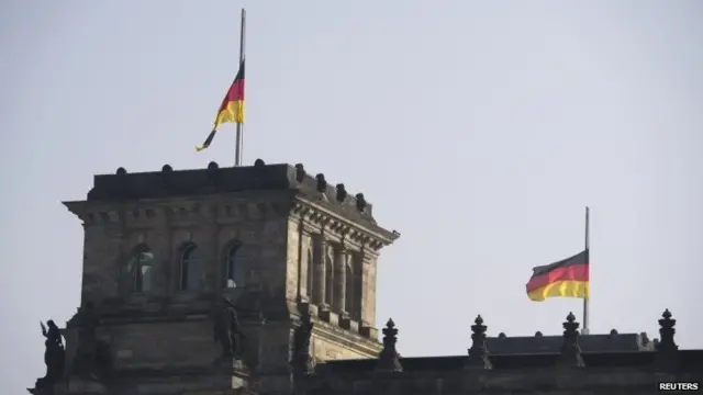 Flags flutter at half-mast on top of the Reichstag building, the seat of the German lower house of parliament - or Bundestag - in Berlin on Wednesday.