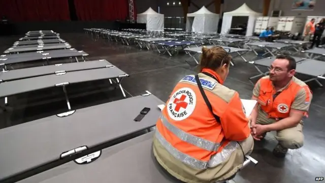 French Red Cross staff wait to greet the families of victims of the Germanwings Airbus A320 at the convention centre of Digne-les-Bains