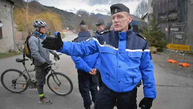 Gendarmerie direct people in the village as rescue workers continue their search operation near the site of the Germanwings plane crash near the French Alps on March 25, 2015 in La Seyne les Alpes, France.