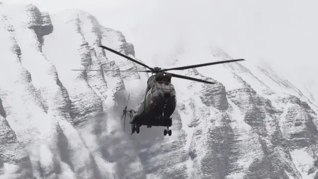 A helicopter flies near Seyne, south-eastern France, on March 25, 2015, near the site where a Germanwings Airbus A320 crashed in the French Alps (BORIS HORVAT/AFP/Getty Images)