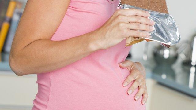 Pregnant woman eating chocolate