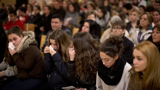 Friends of the German students from the crashed plane attend a mass in Llinars del Valles, near Barcelona, Spain, on 24 March, 2015