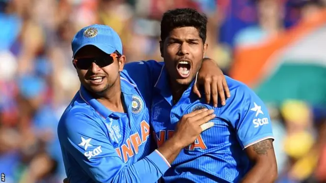 Umesh Yadav (right) is congratulated by team-mate Suresh Raina (left)