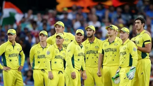 Australian players watch a giant screen as they review an appeal