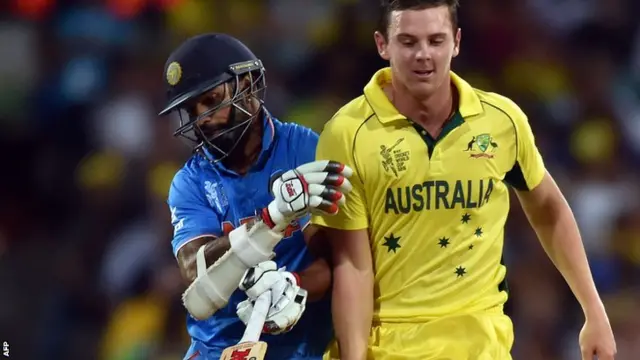 India's batsman Shikhar Dhawan (L) collides with Australia"s paceman Josh Hazlewood (R) during the Cricket World Cup semi-final at Sydney Cricket Ground