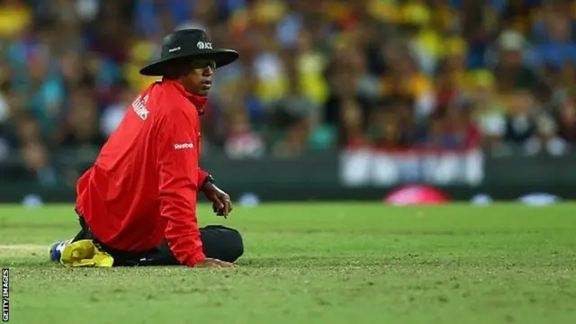 Umpire Kumar Dharmasena looks up from the ground