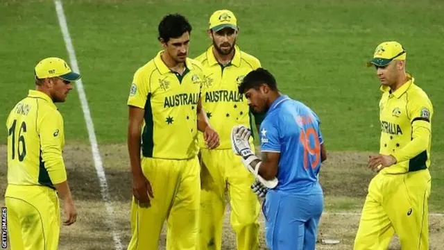 Umesh Yadav of India checks his face after being hit by Mitchell Starc