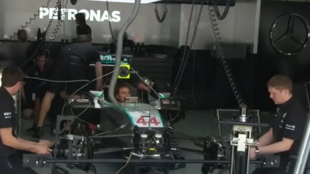 Mercedes technical team look at Lewis Hamilton's Mercedes